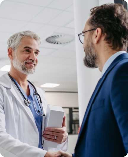 A doctor at a hospital shaking a Pinnacle team member's hand